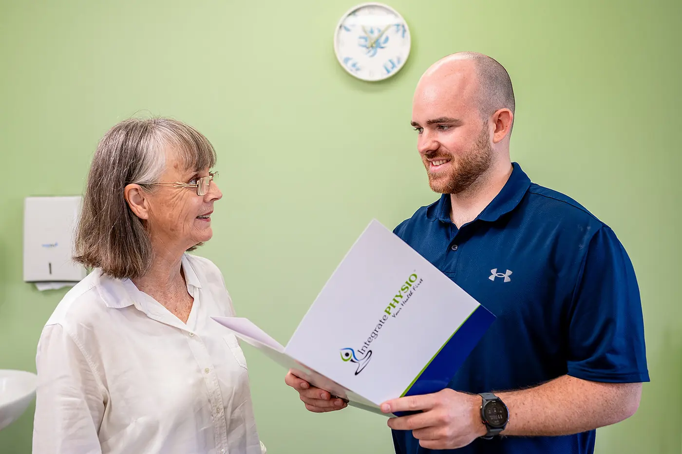 A clinician and patient looking through a care plan together