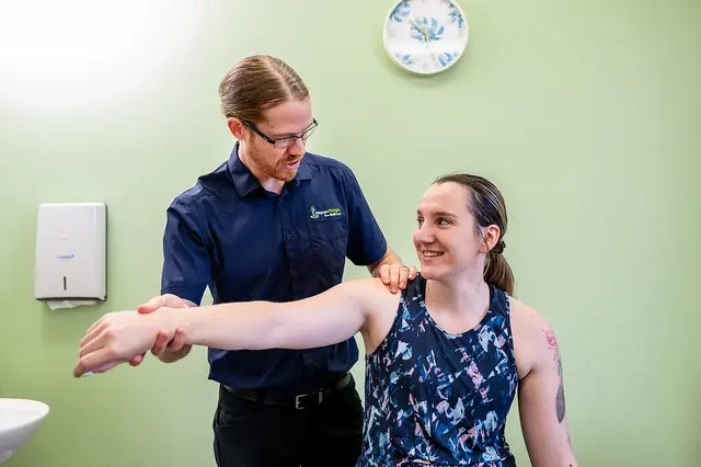 A clinician assessing a patient’s shoulder movement